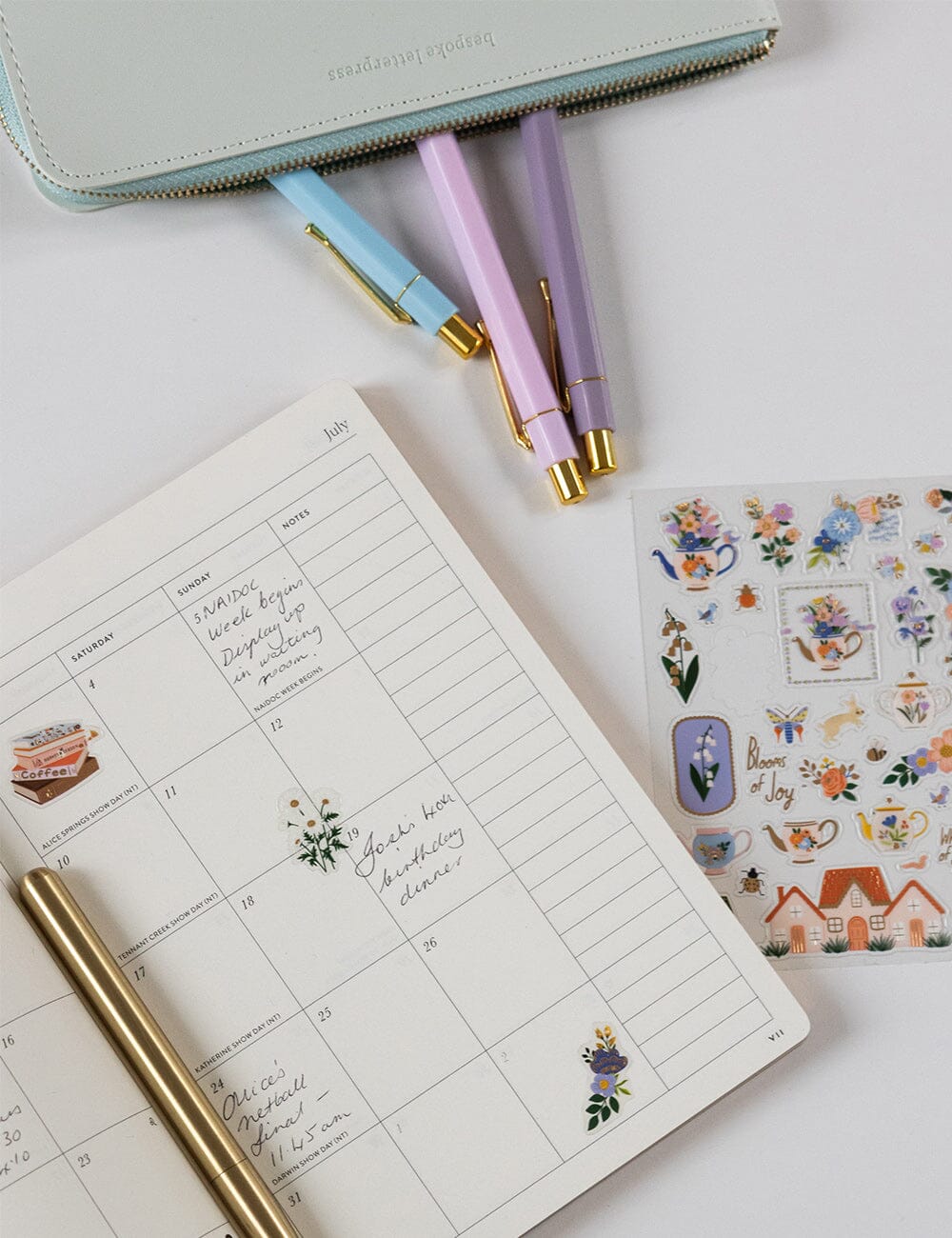 Planner with stickers and pens on a light surface