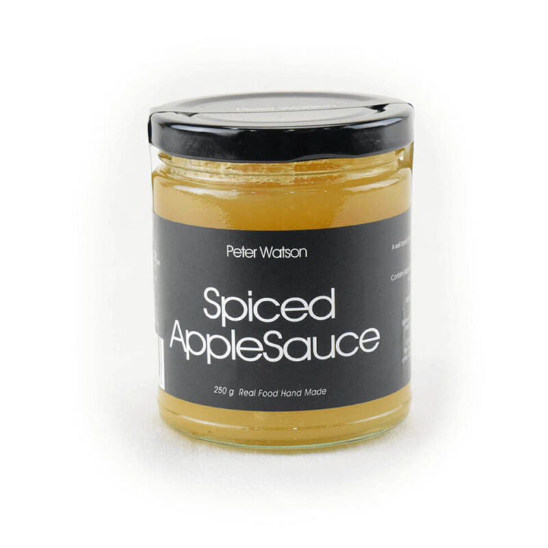 Jar of spiced apple sauce with a black label on a white background