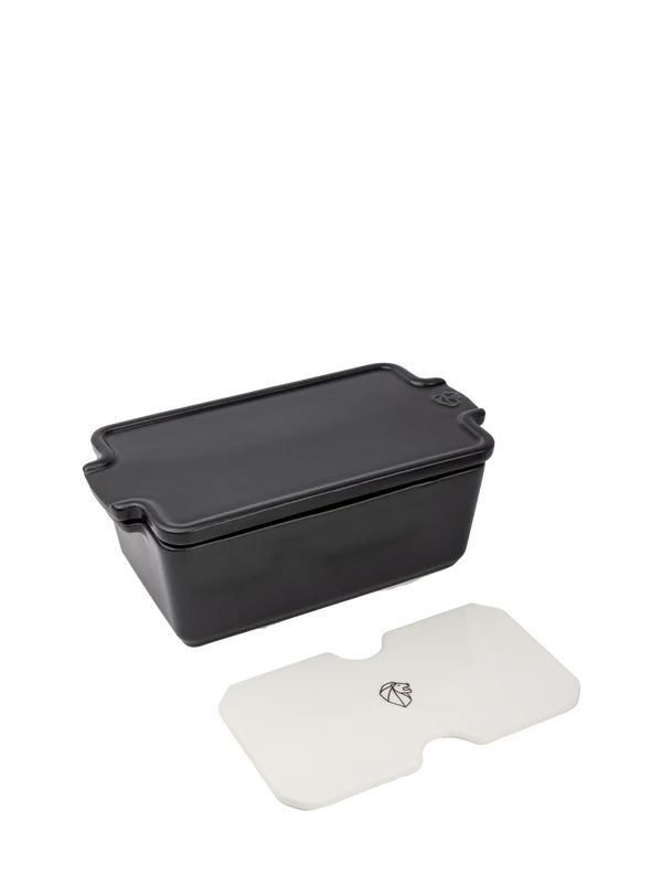 Grey rectangular terrine mould with a white weight on a white background