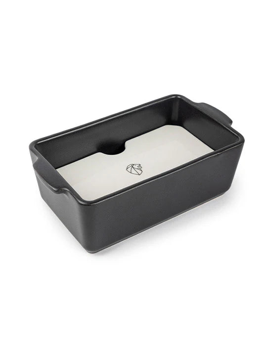 Grey terrine mould with a white press on a white background