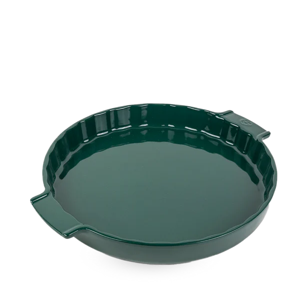 Green ceramic pie dish on a white background