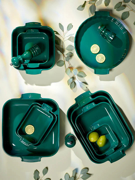 Set of green ceramic dishes on a light background