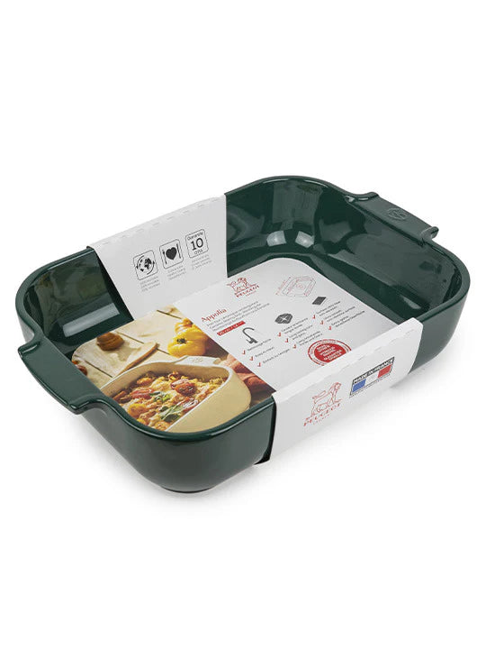 Green ceramic baking dish with a recipe card inside on a white background