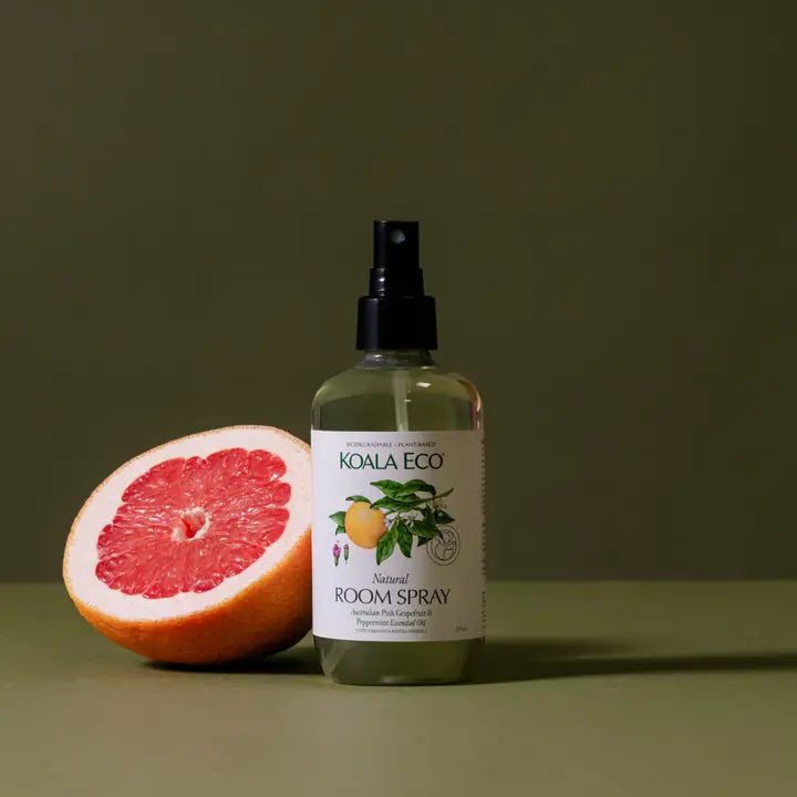 Koala Eco room spray bottle with a half-grapefruit on a green background