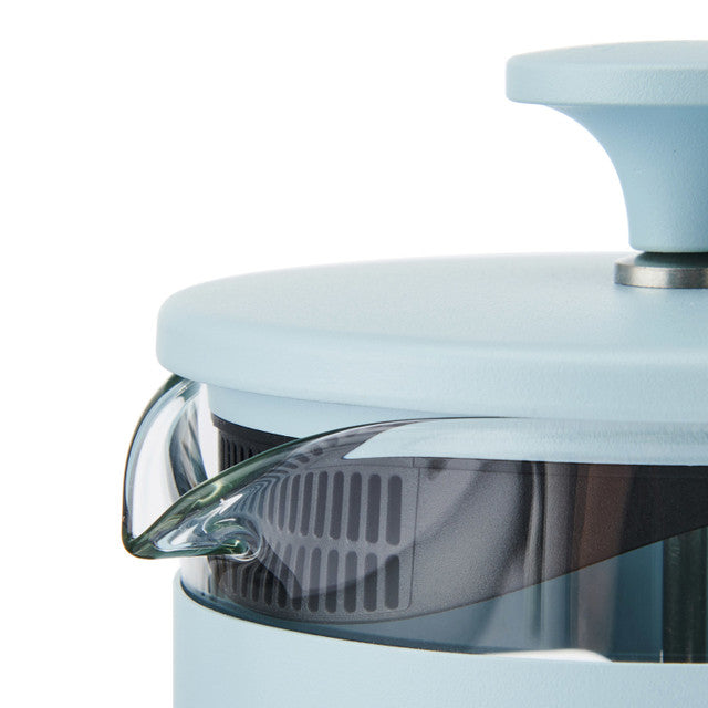 Close-up of a light blue kitchen appliance with a clear glass lid on a white background