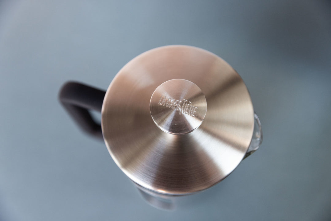 Close-up of a metallic lid with a brand logo on a blurred background