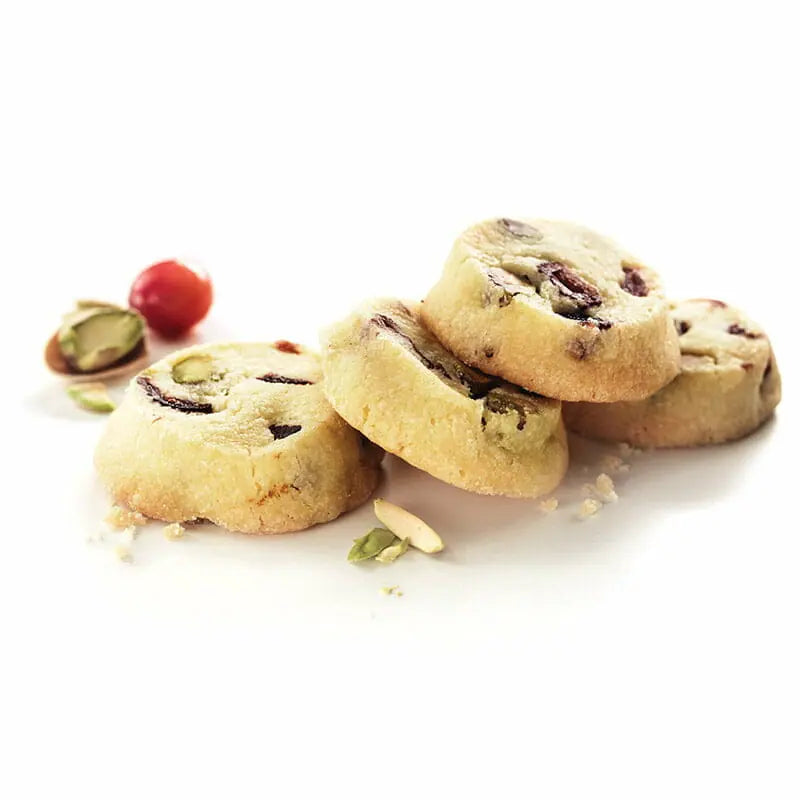 Stack of cookies with pistachios and cranberries on a white background