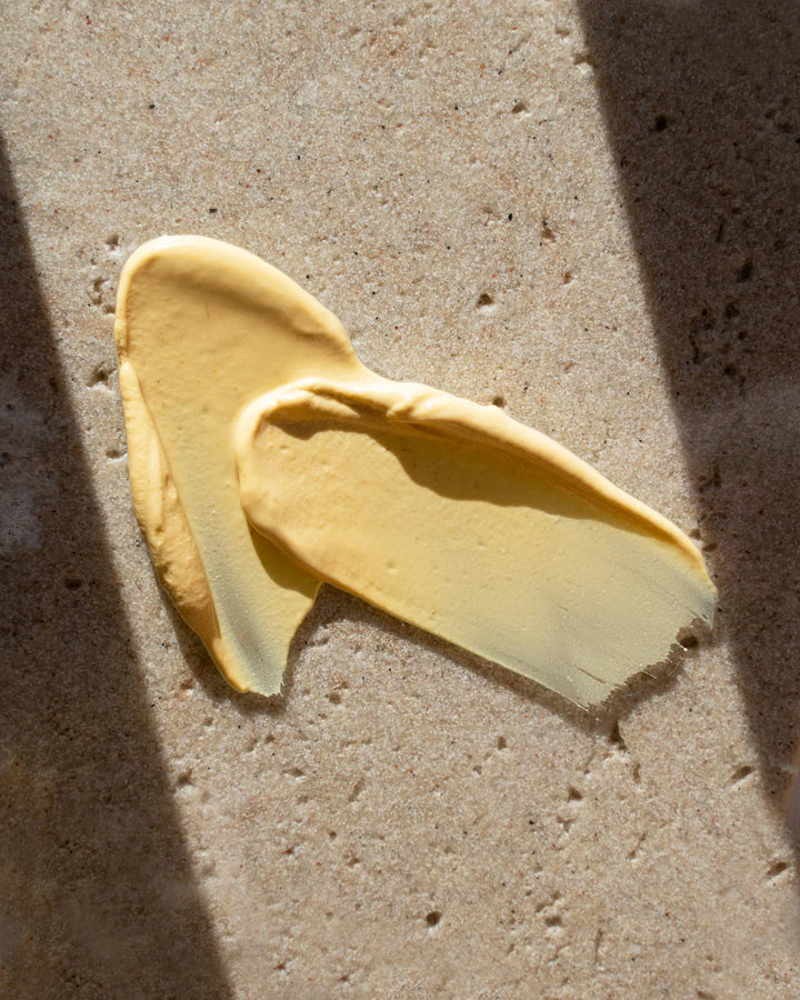 Swatch of a yellow face mask of a textured surface.