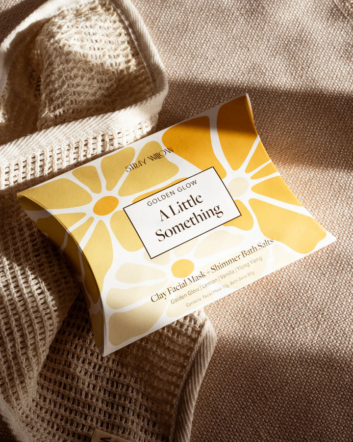 Packaged product with yellow and white design on a textured fabric background