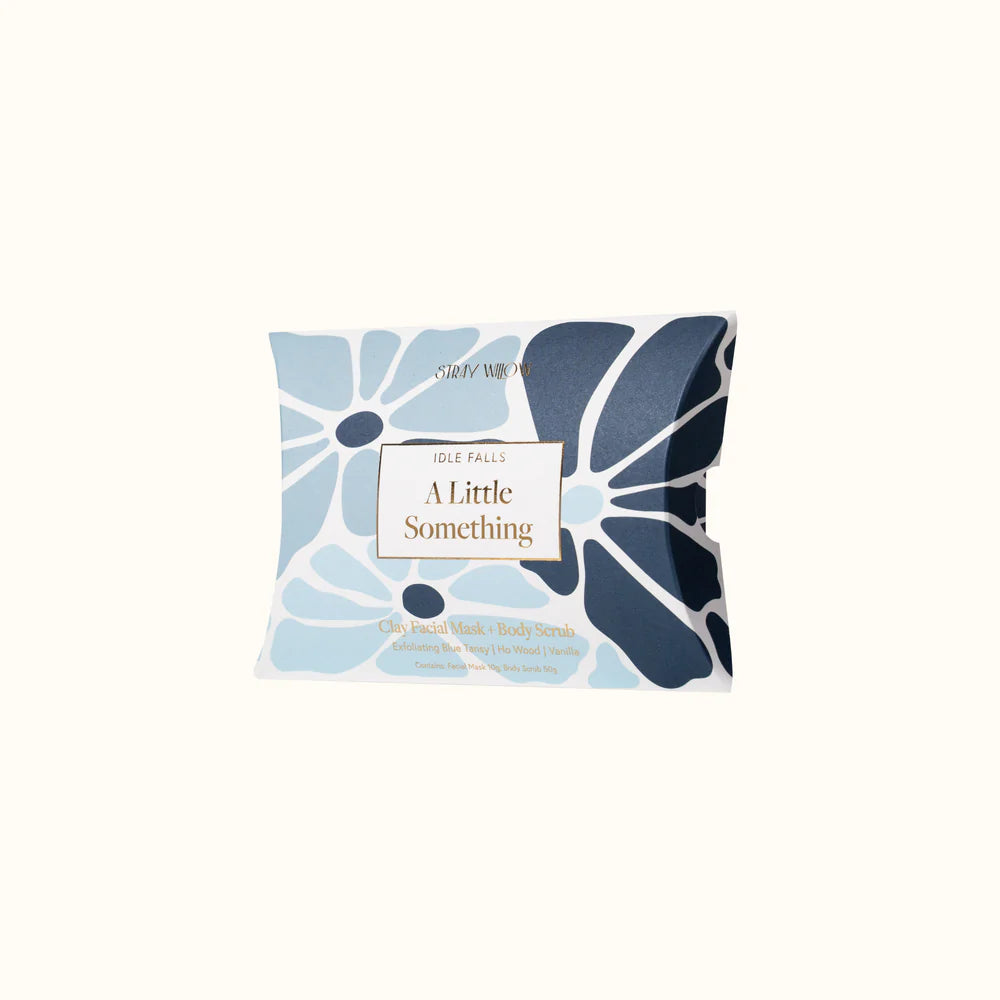 Face mask packaging with blue floral design on a white background