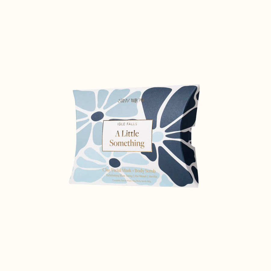 Face mask packaging with blue floral design on a white background
