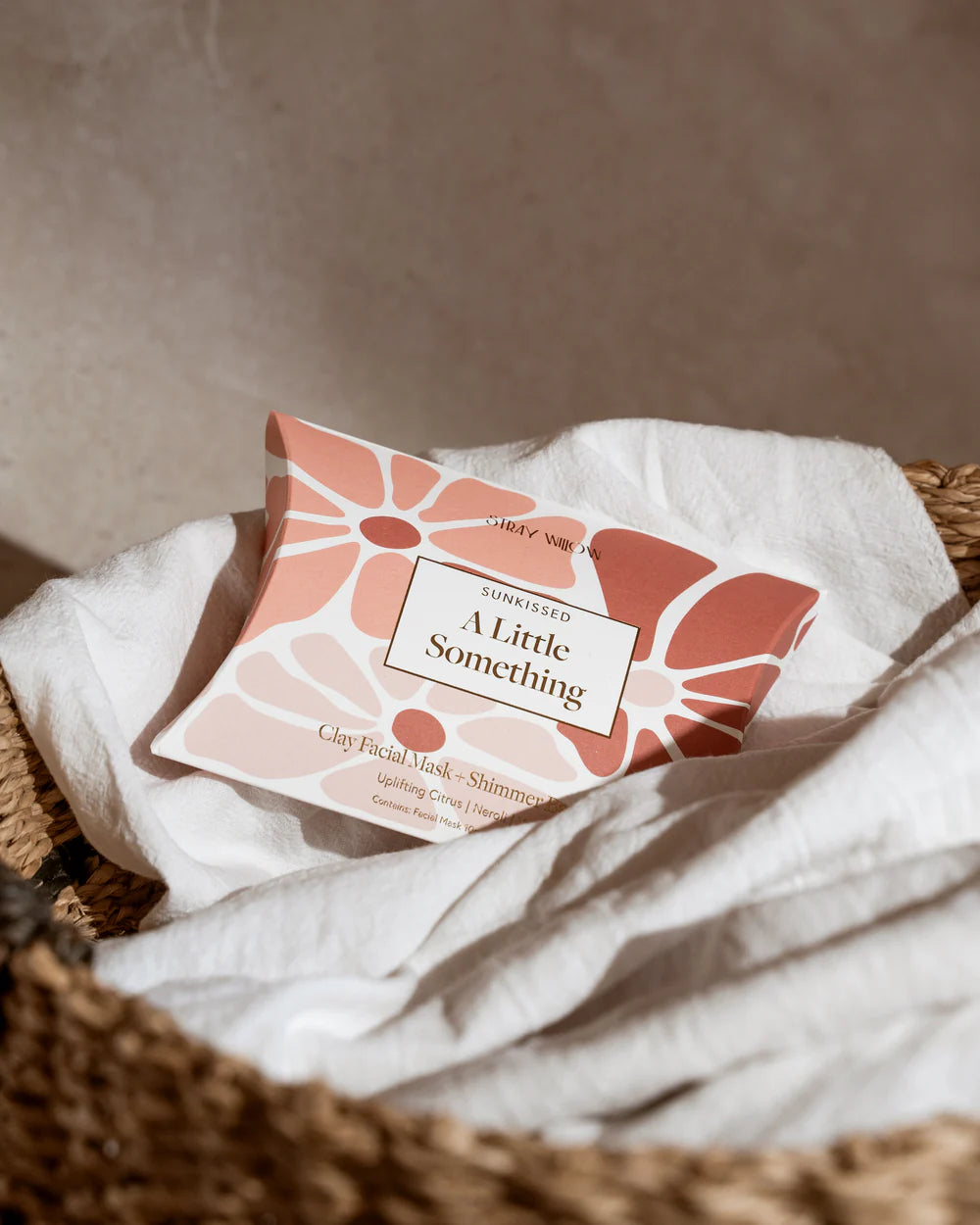 Product packaging labeled 'A Little Something' on a textured surface