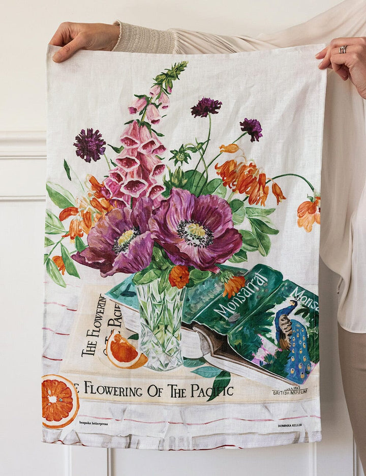 Floral design tea towel held by a person