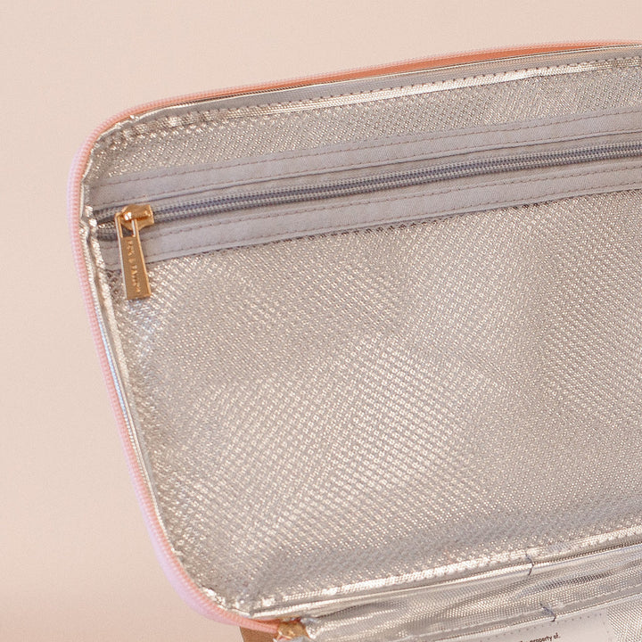 Inside of an insulated lunch bag with a zipper on a beige background