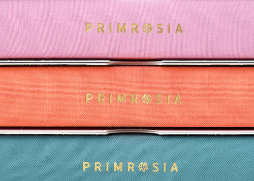 Three Primrosia products stacked on top of each other with visible branding.