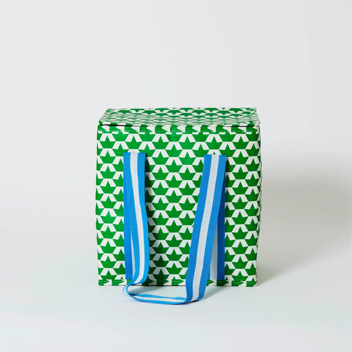 Green and white patterned bag with blue straps on a light gray background