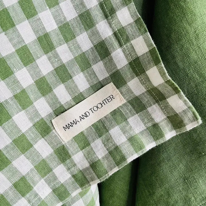 Green and white checkered linen tea towel with a label reading 'Mama and Tochter'.