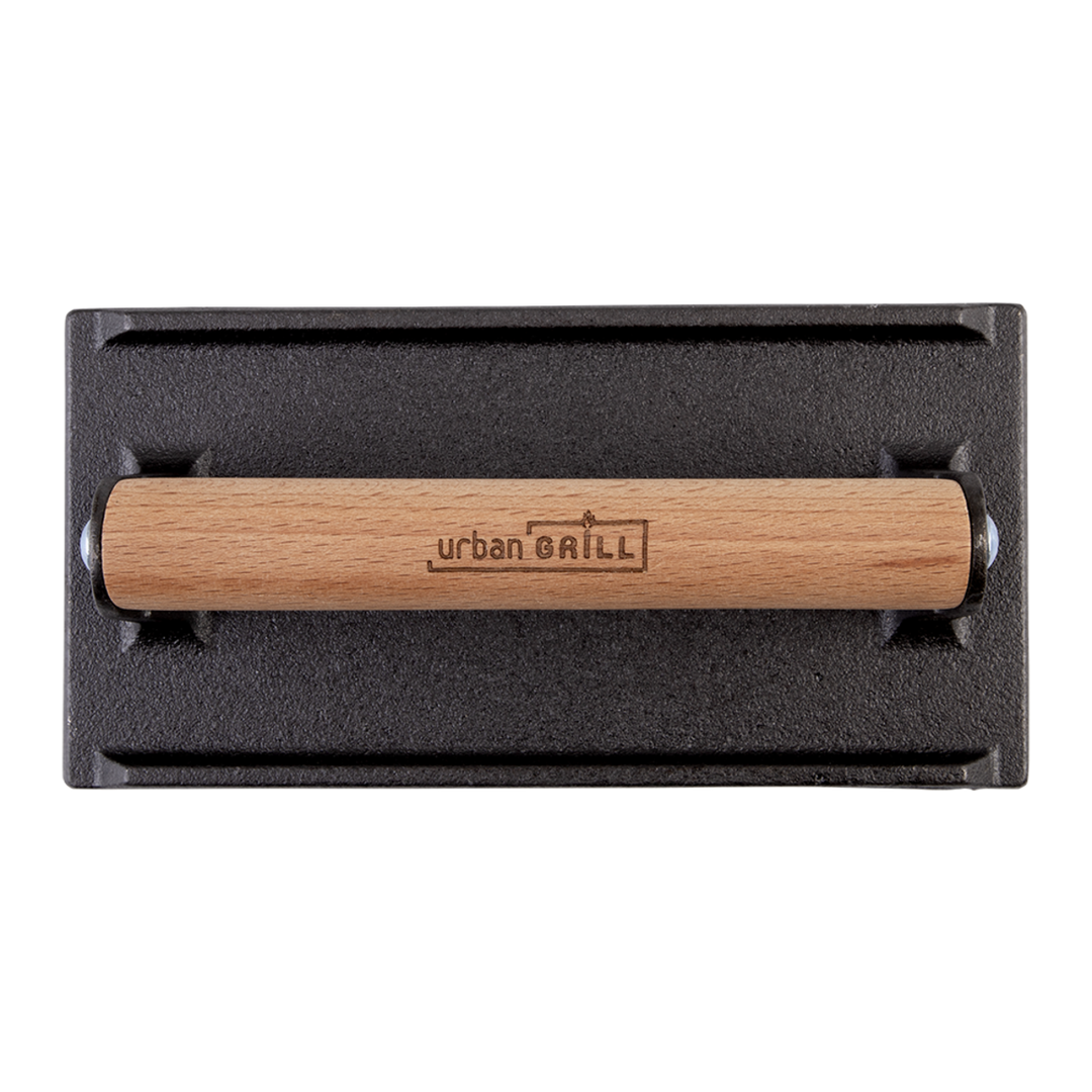Black cast iron grill press with wooden handle on a white background
