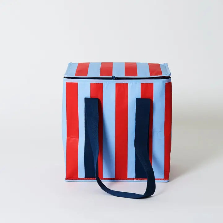 Striped cooler bag with red, blue, and white pattern on a light gray background