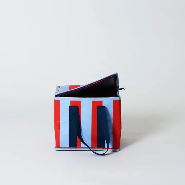 Striped bag with red, white, and blue pattern on a light gray background