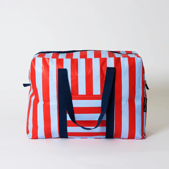 Striped bag with red, white, and blue pattern on a light gray background