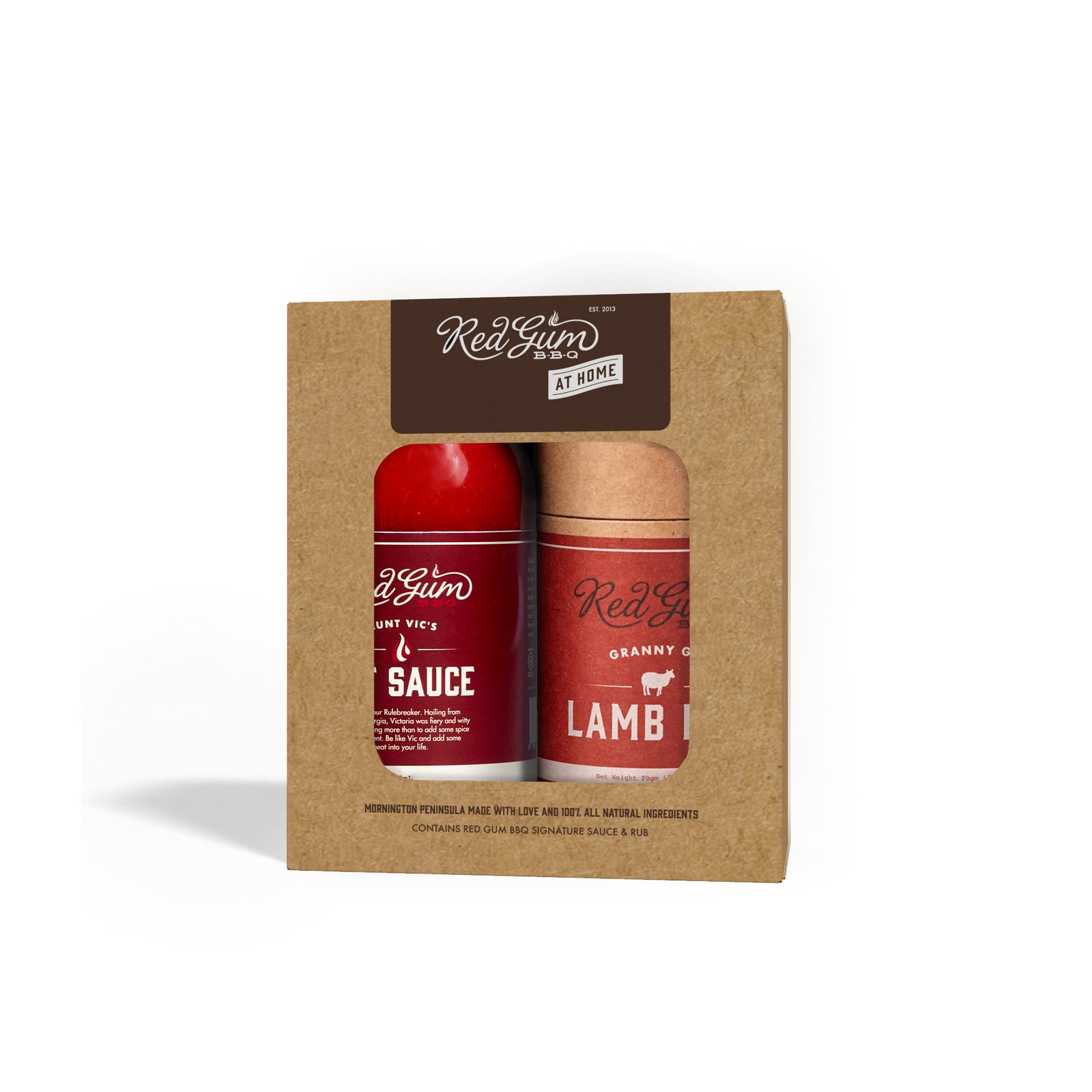 A gift box containing two bottles of Red Gum BBQ sauce and lamb rub, with the brand's logo and product names visible on the packaging.