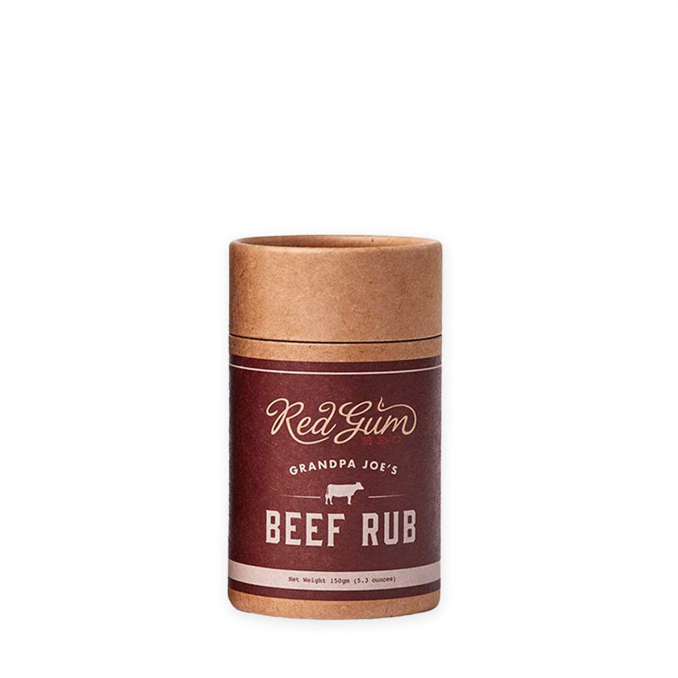 A cylindrical container of Red Gum Grandpa Joe's Beef Rub with a label featuring text and branding.