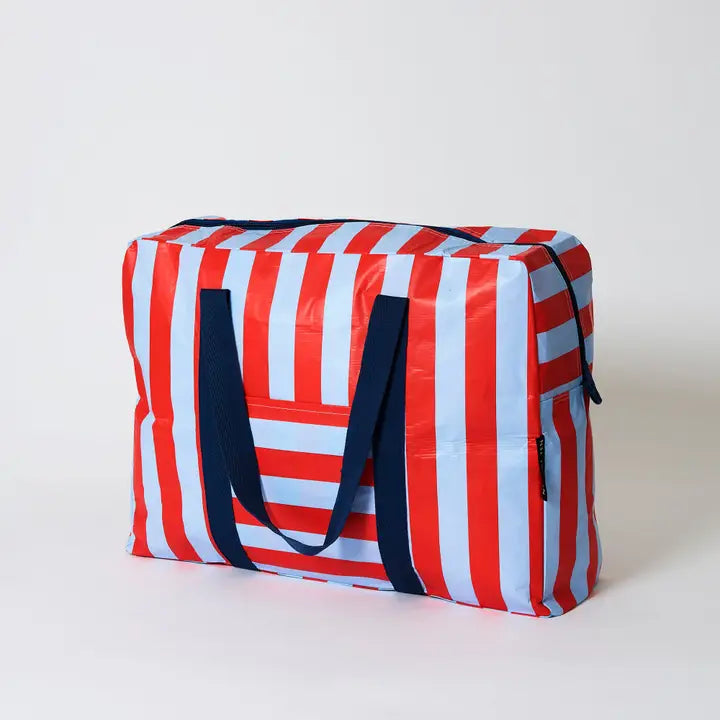 Striped bag with red, white, and blue colors on a light gray background