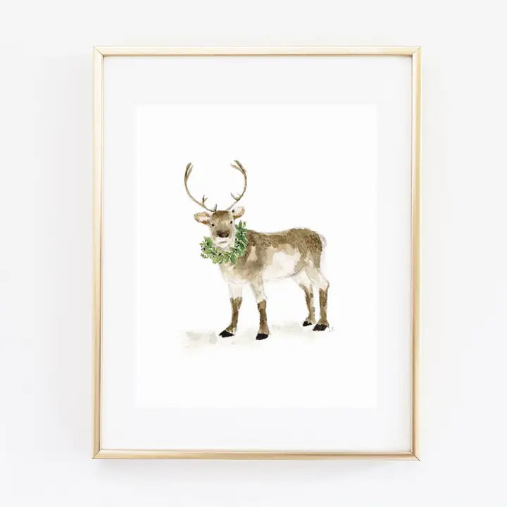 Emily Lex watercolour art print of a reindeer with a christmas wreath around its neck in a brass frame