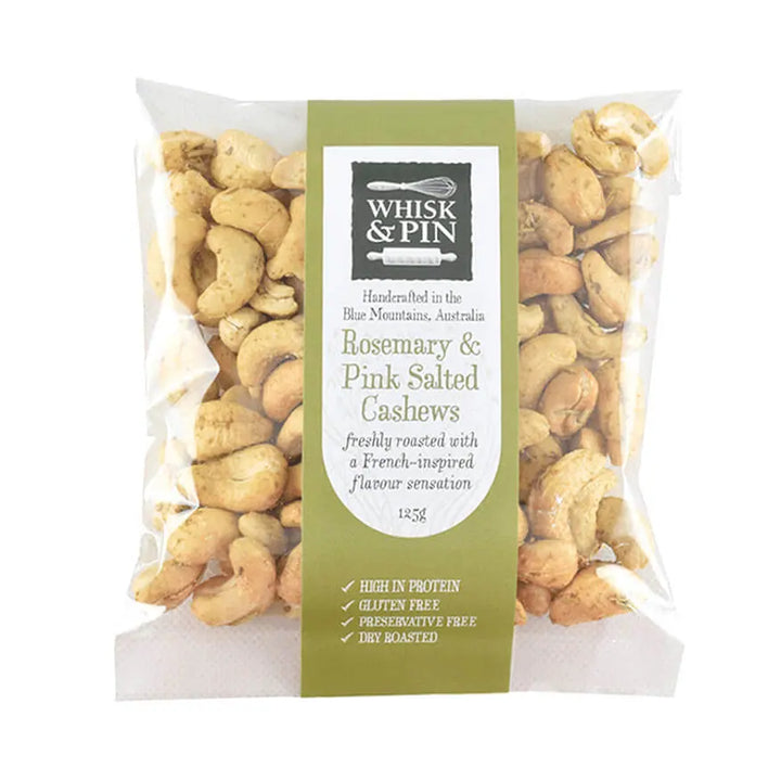 Packaged rosemary and pink salted cashews with Whisk &amp; Pin branding on a white background