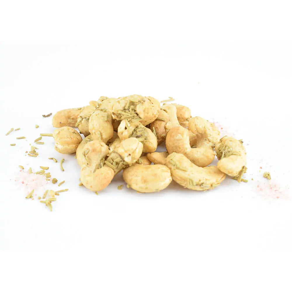 Cashew nuts with herbs on a white background