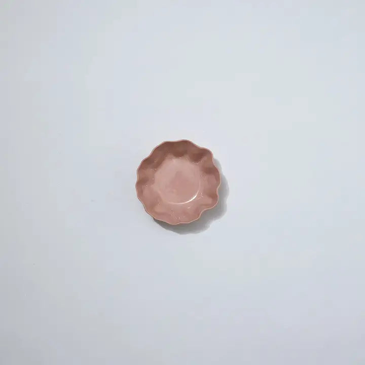 Small pink ceramic dish on a light gray background