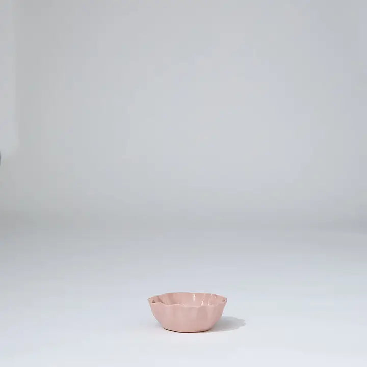 Small pink bowl on a light gray background