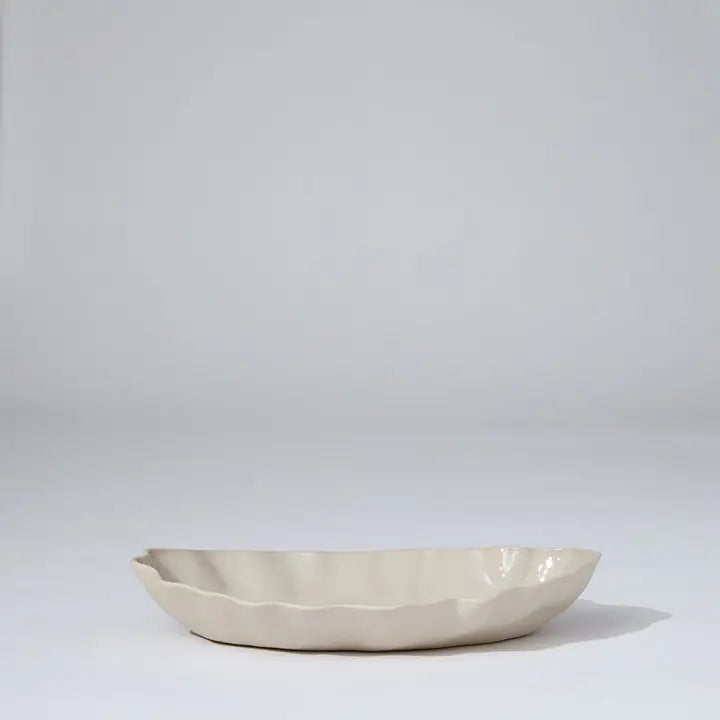 Beige ceramic bowl on a light gray background