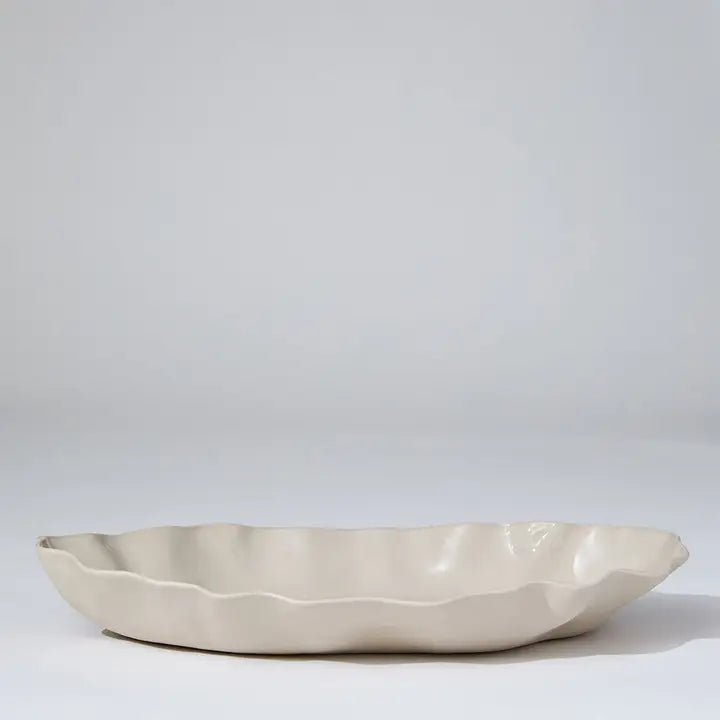 Beige ceramic dish on a light gray background