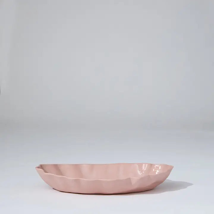 Pink ceramic bowl on a light gray background