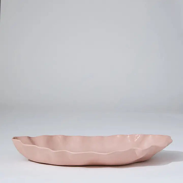 Pink ceramic dish on a light gray background