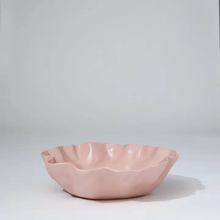 Pink ceramic bowl on a light gray background