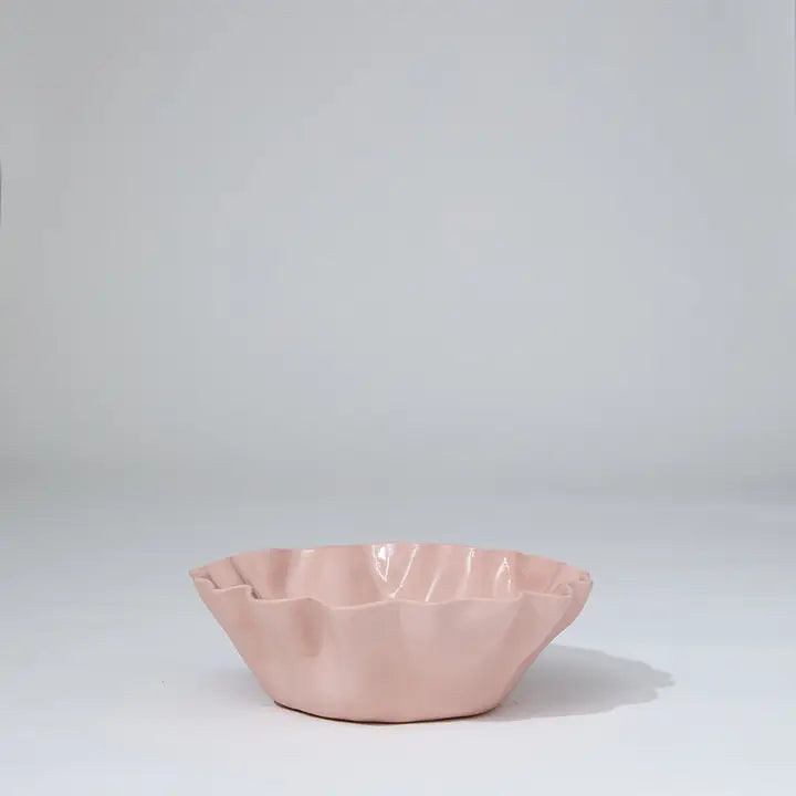 Pink ceramic bowl on a light gray background