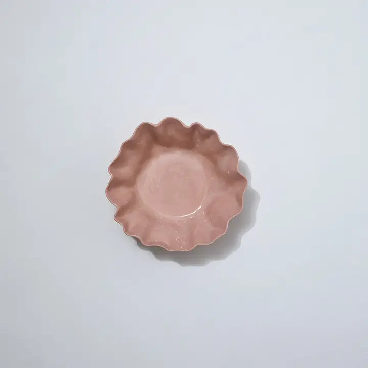 Pink ceramic dish on a light gray background