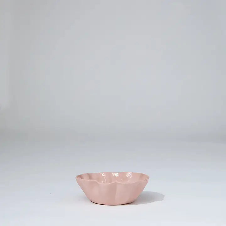 Pink ceramic bowl on a light gray background