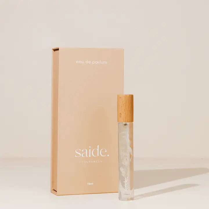 Perfume bottle with wooden cap and beige packaging labeled 'saide.' on a light background