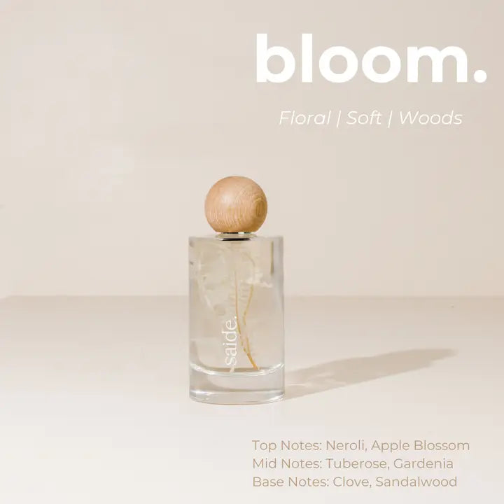 Interior Fragrance bottle with wooden cap on a light background, featuring the brand 'bloom'.