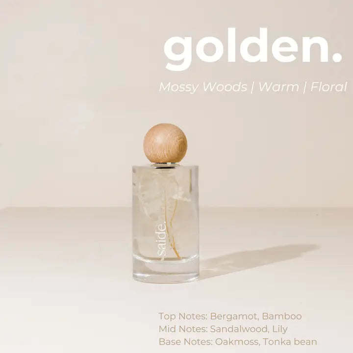 Interior fragrance bottle with wooden cap on a light background, featuring the brand 'golden'.