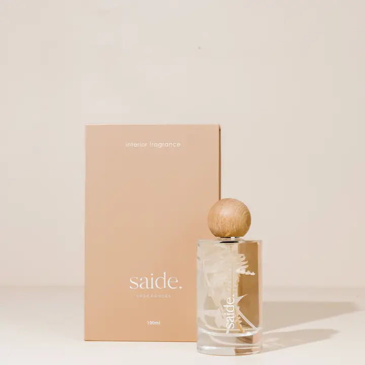 Saide interior fragrance with wooden cap and matching box on a light background