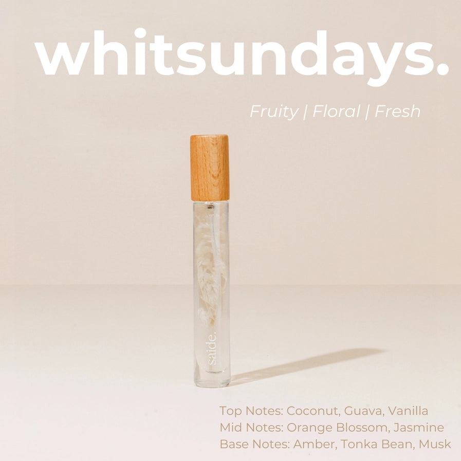Roll-on parfum bottle with wooden cap on a beige background, featuring the brand 'whitsundays'.