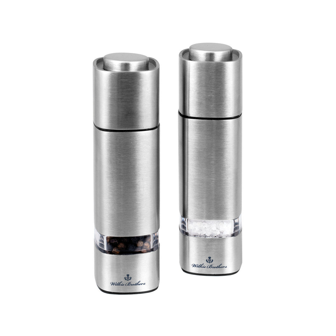 Two silver pepper mills on a white background