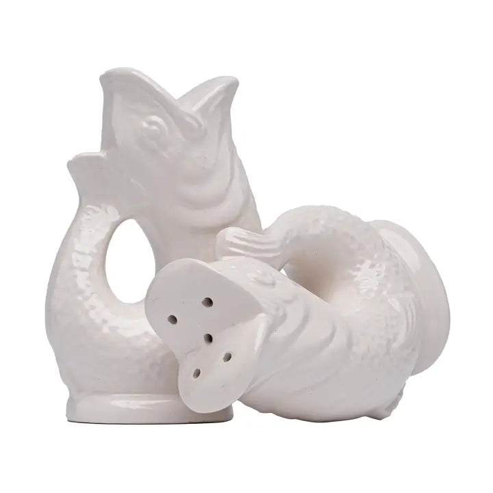 White ceramic salt and pepper shakers shaped like a fish on a white background