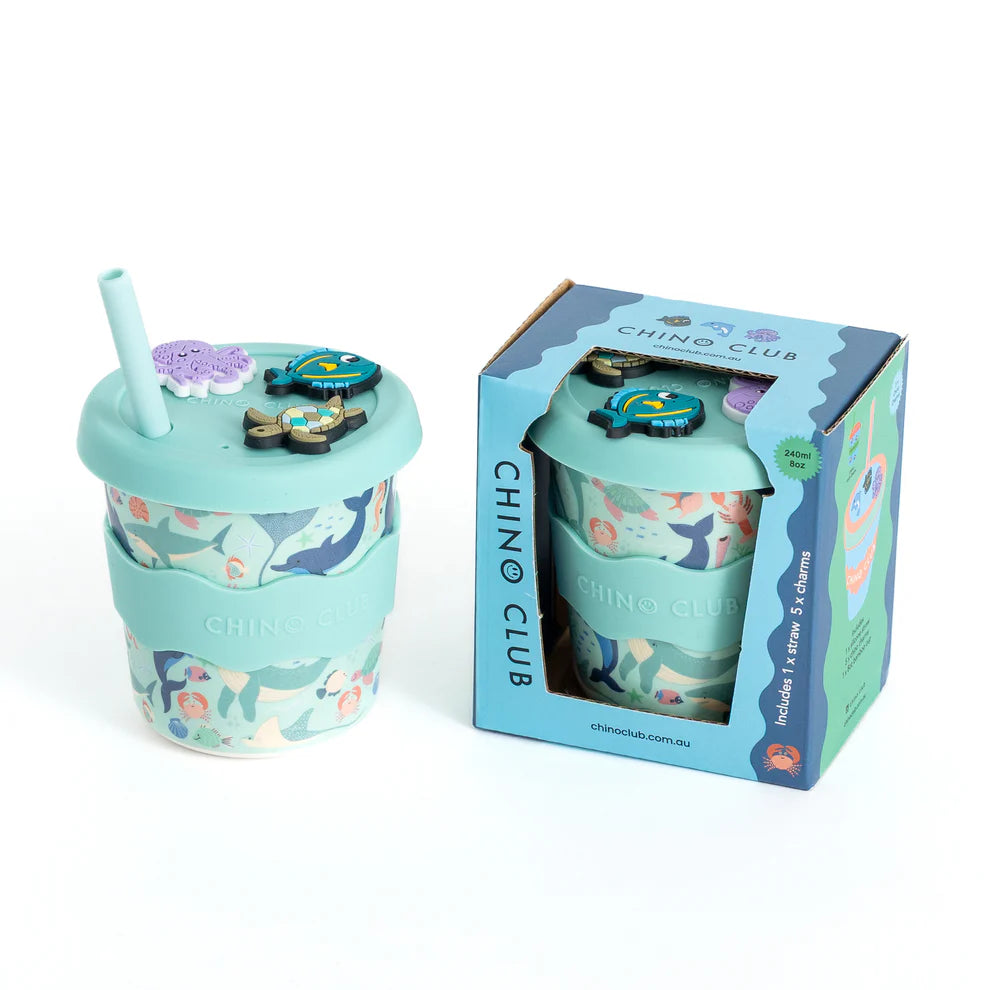 Children's cup with ocean designs and straw, displayed with packaging on a white background.
