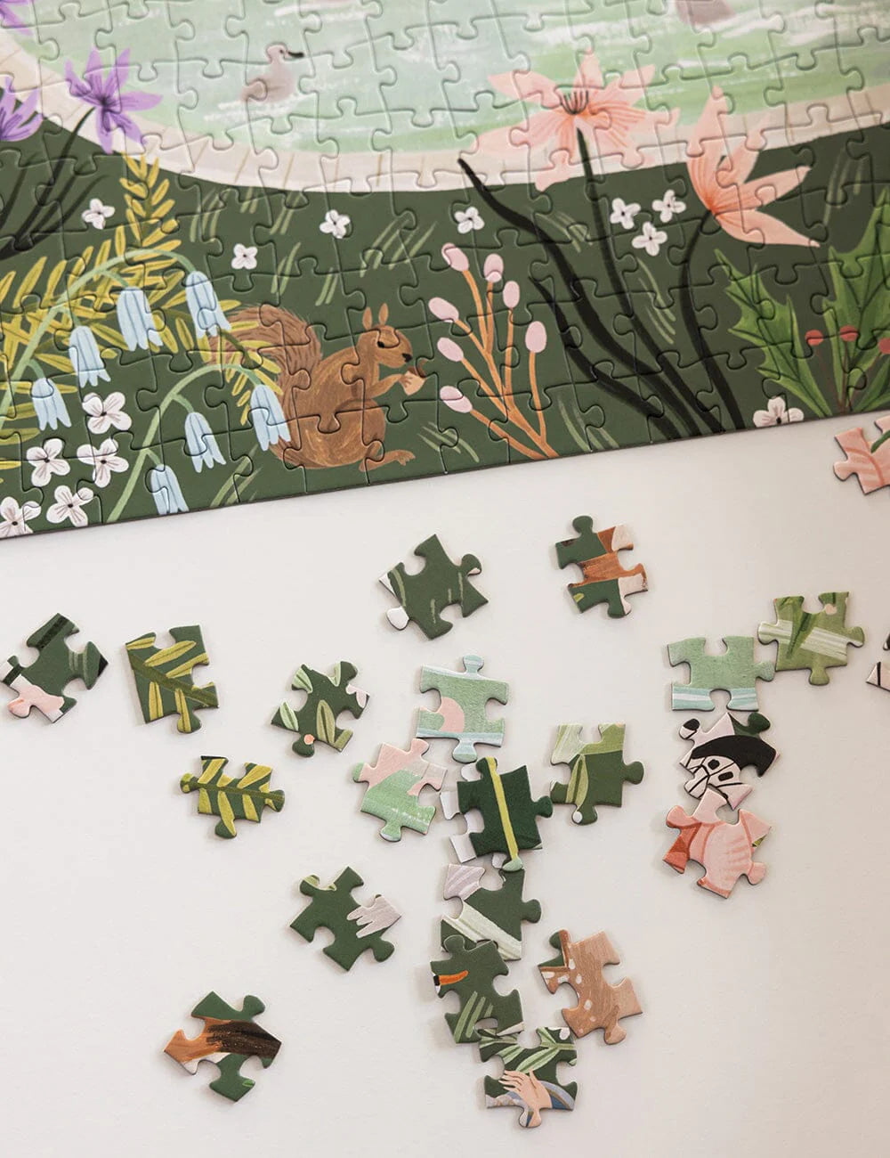 Jigsaw puzzle with completed pieces and missing ones on a white surface
